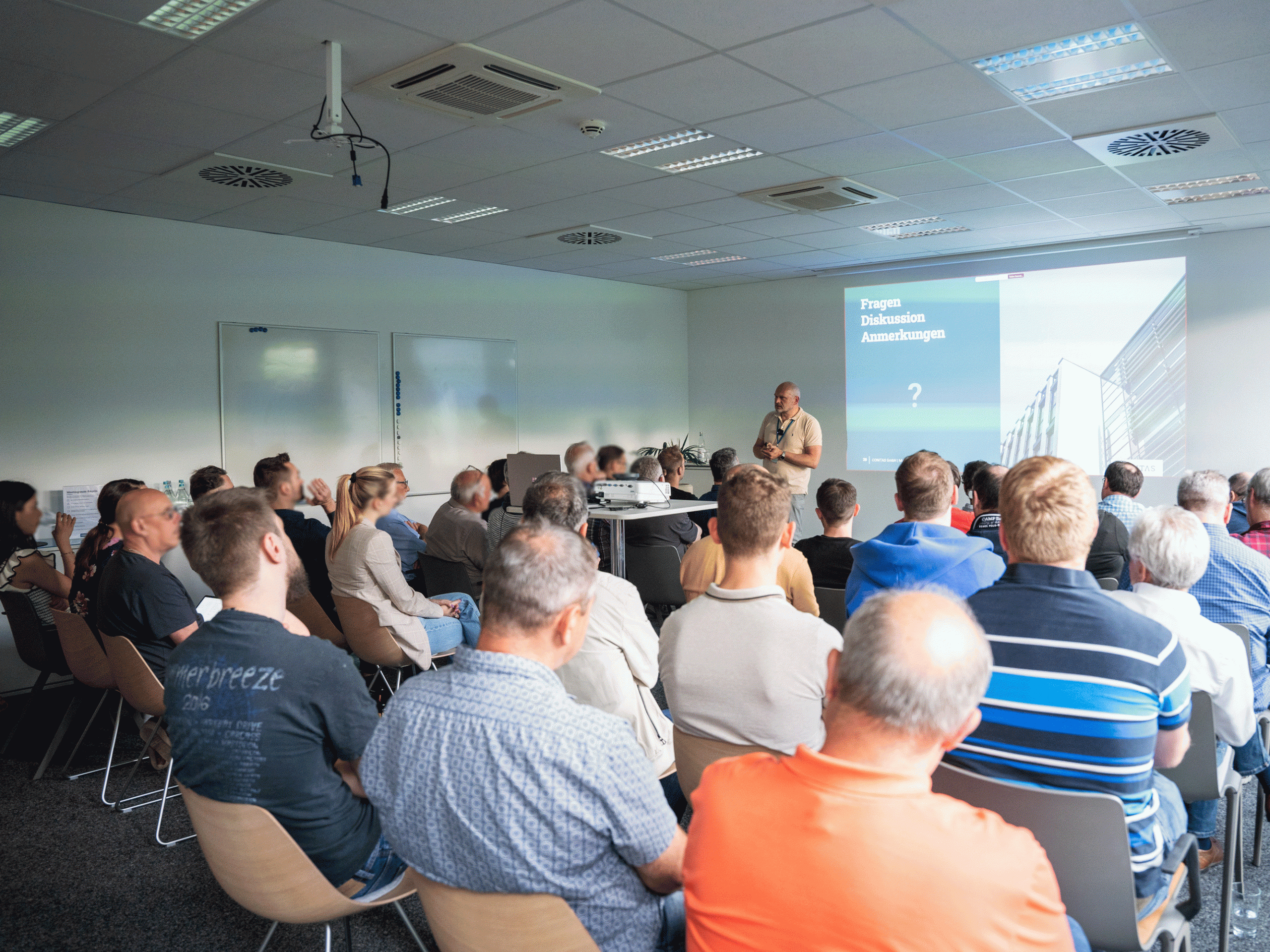 Johann von der CONITAS spricht bei einem Vortrag zum Thema IT-Sicherheit im Zeitalter künstlicher Intelligenz vor einem interessierten Publikum.